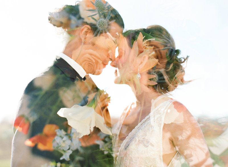 Silhouette of bride and groom embracing standing forehead to forehead