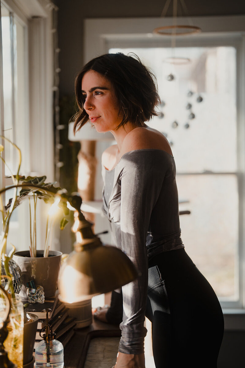 yoga teacher in atlanta looking out window