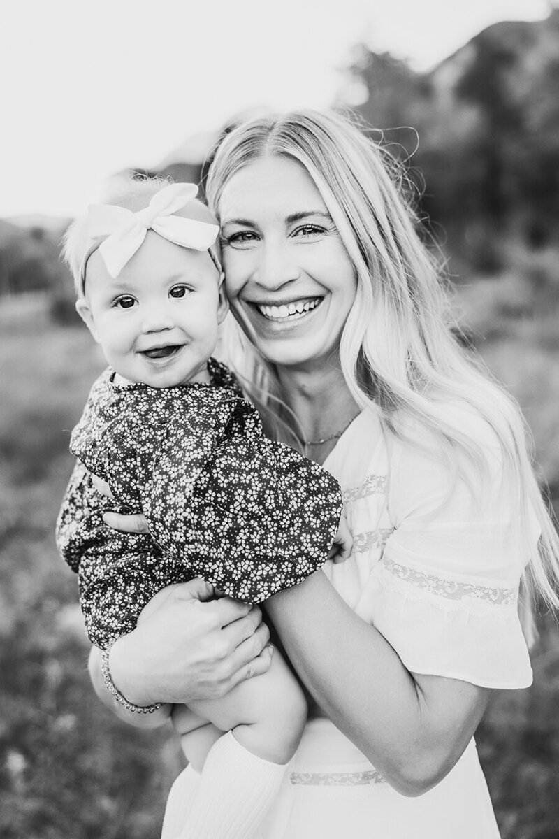 Mom and baby girl snuggling together