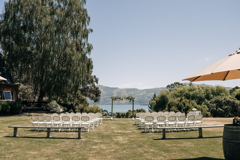 the ceremony lawn at mt vernon lodge in akaroa set up for a wedding overlooking the water