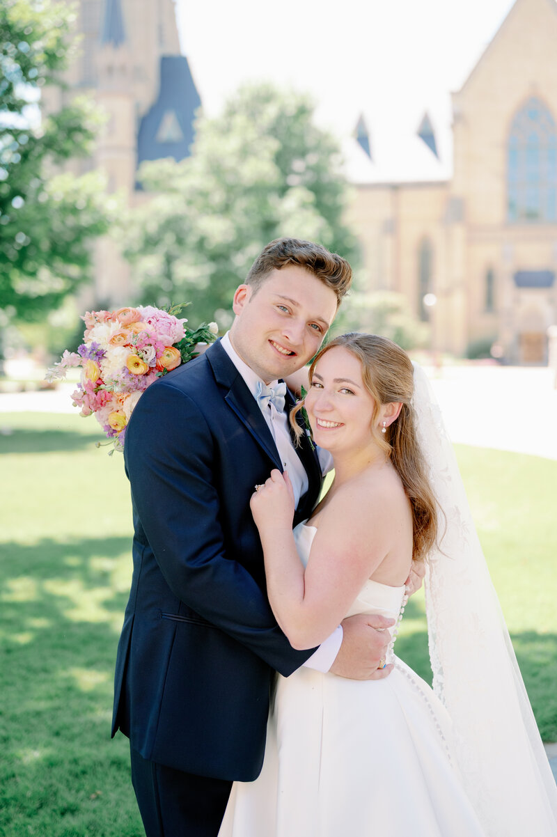 bride and groom smiling on a sunny day at Notre Dame