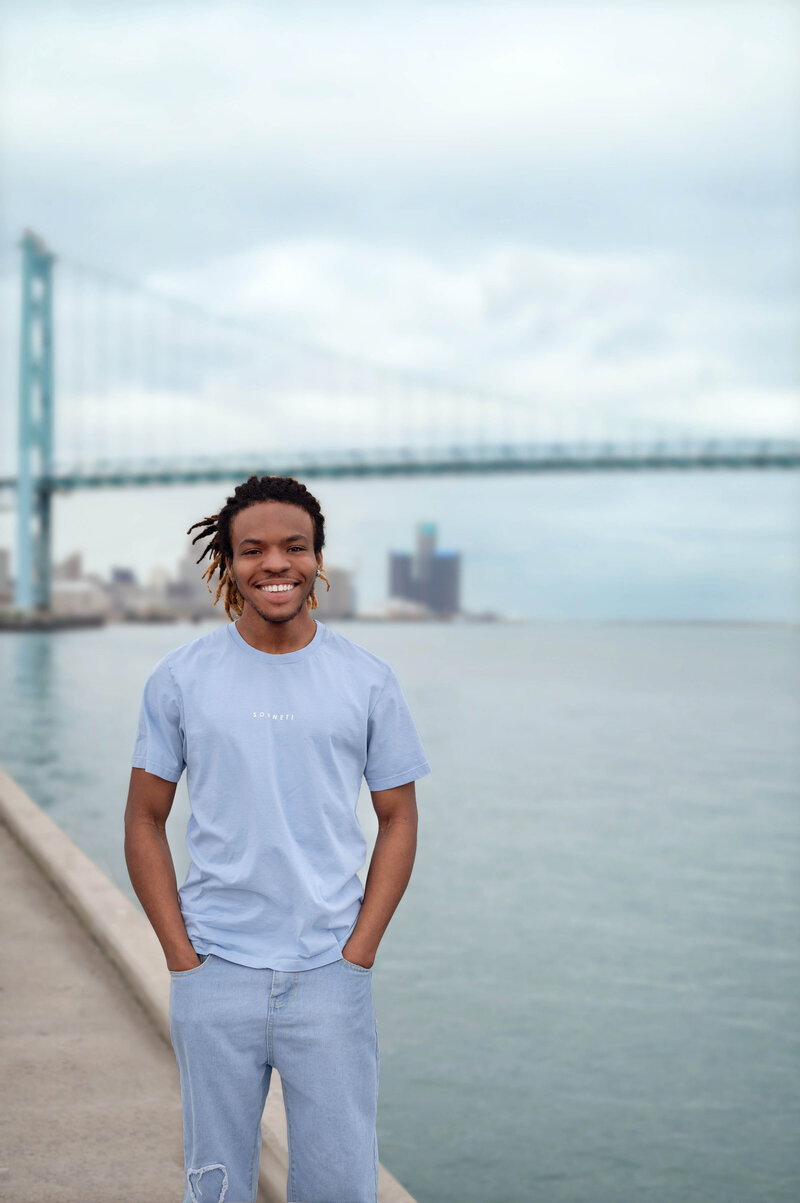 High school senior wearing a football jersey smiling at the camera