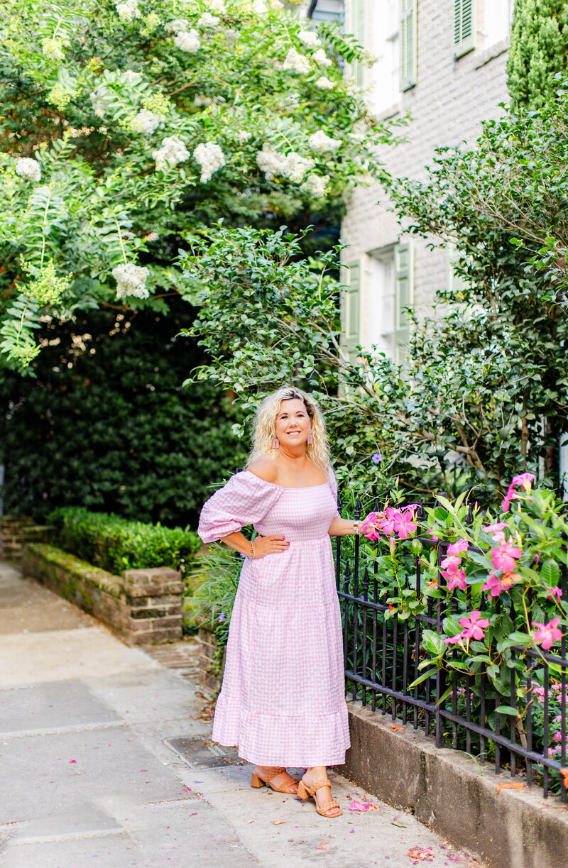 branding session in Charleston South Carolina in pink dress with pink flowers and iron fence