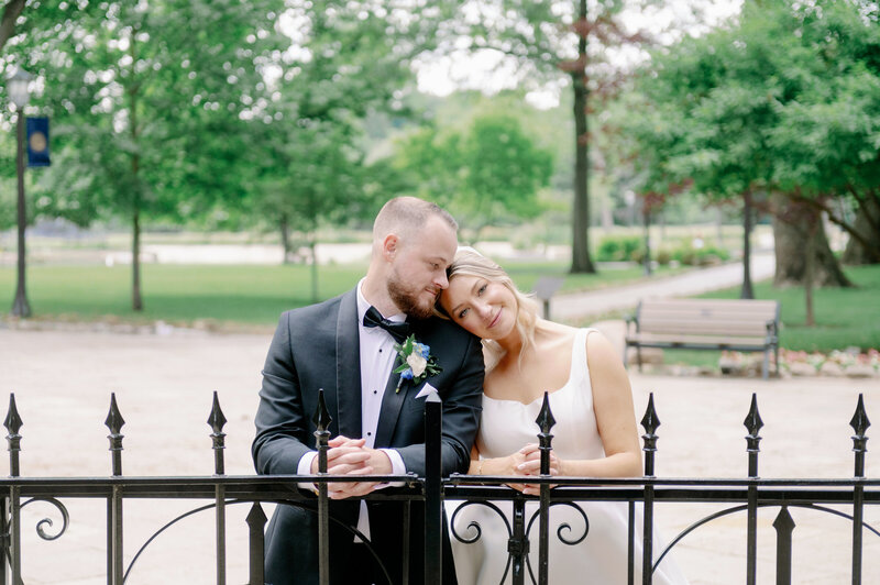 a bride resting her head on her groom's shoulder