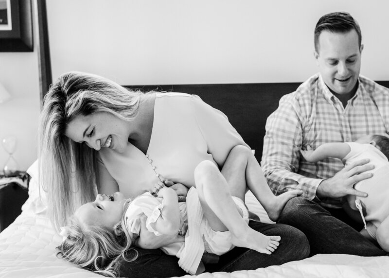 mom tickling little girl