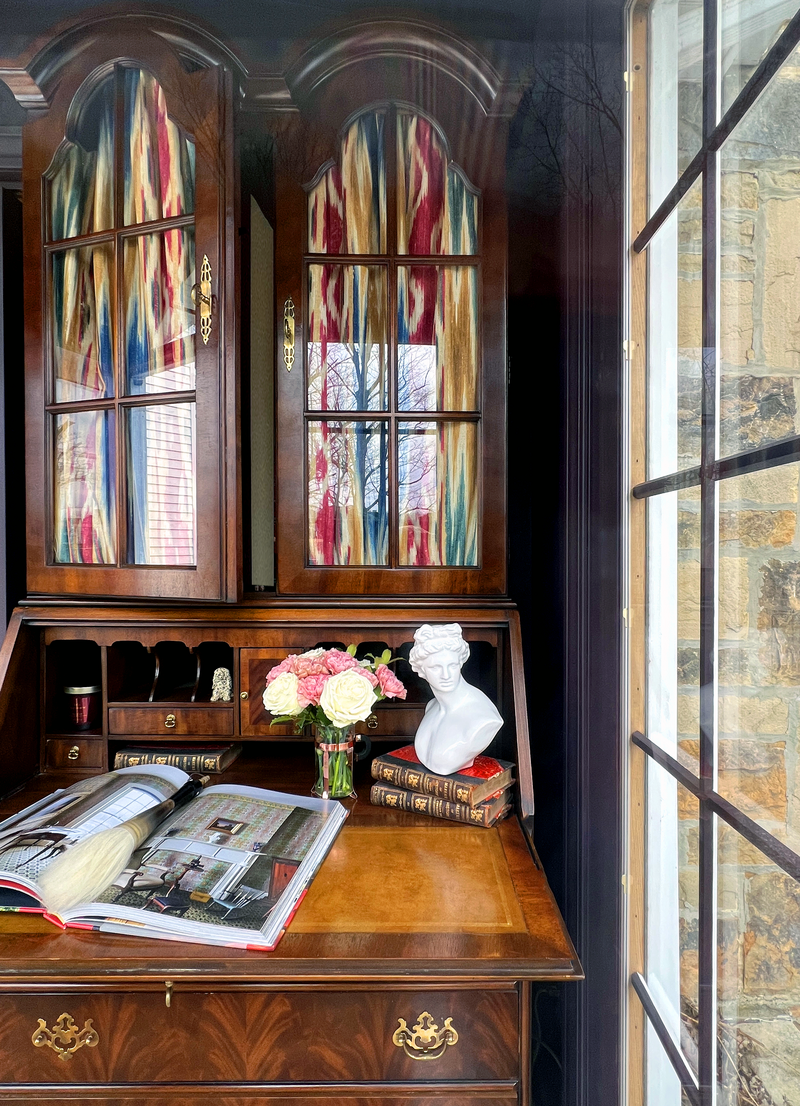 Antique secretary styled with a Grecian bust and vintage books.