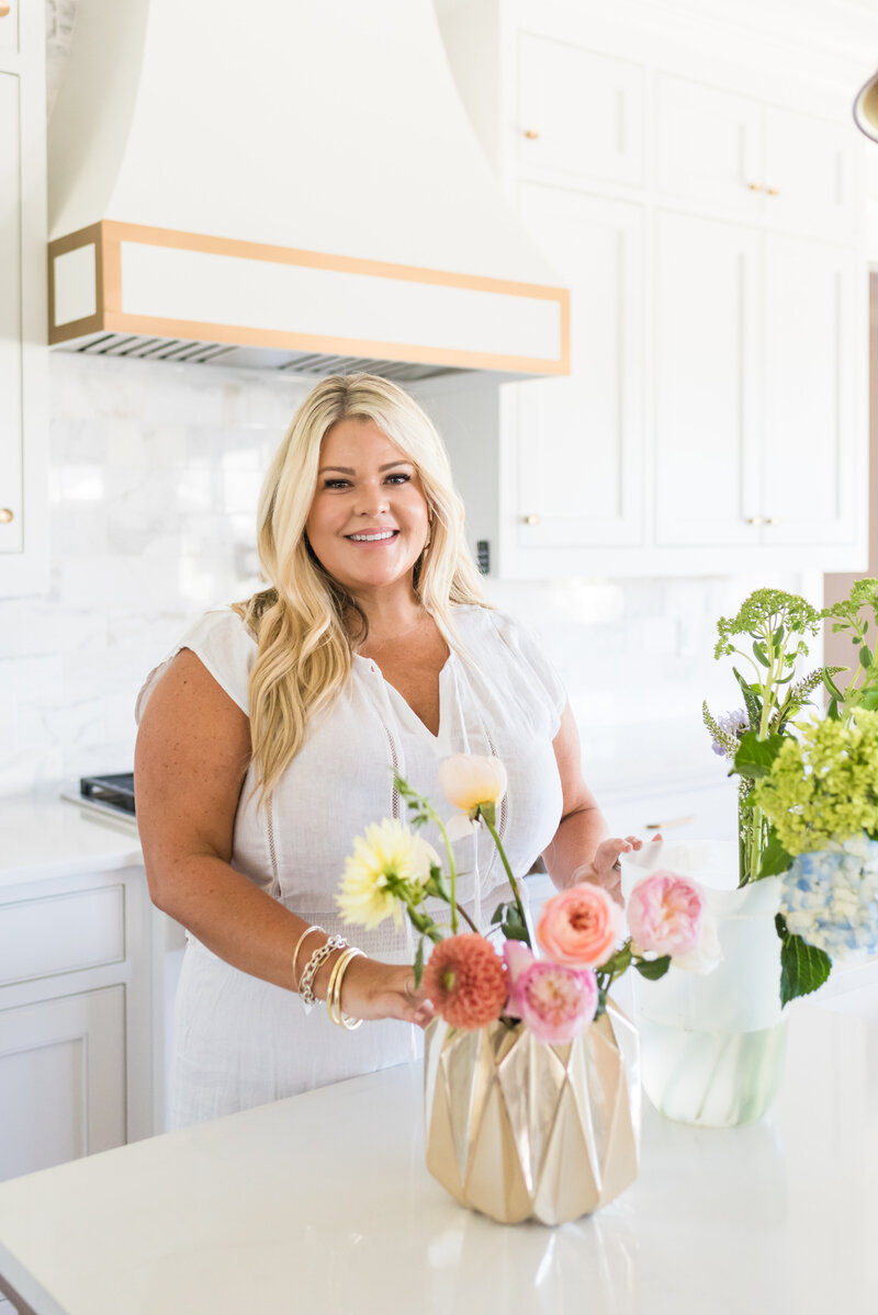 Erynn standing with flowers in kitchen