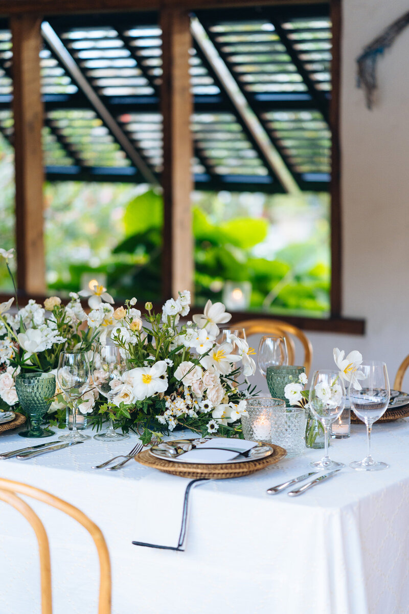 White floral centerpieces on table