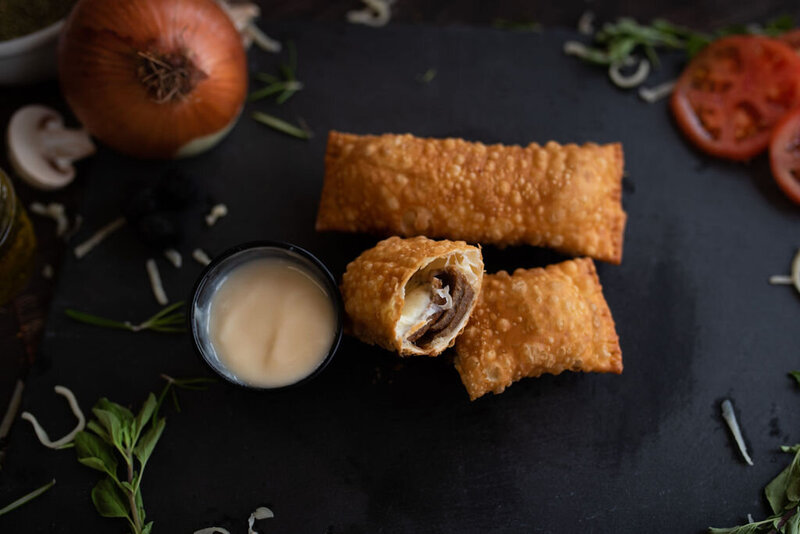 Crispy Redo’s donair egg rolls with seasoned beef, cheese, and a side of donair sauce—customer-favourite appetizer in Nova Scotia