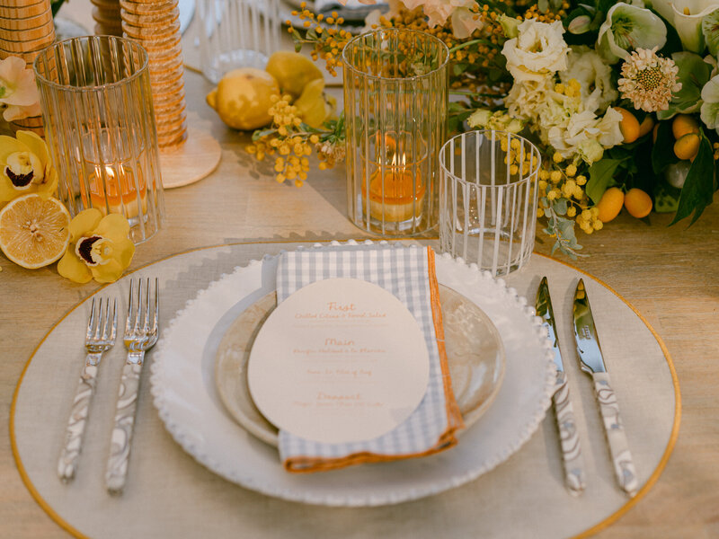 Basking in the golden glow of a citrus summer at the iconic Bahia Resort in San Diego, I had the absolute pleasure of capturing a scene of serene elegance. Tucked away in a secluded tropical garden, a charming pergola set the stage for beautifully arranged florals and meticulously styled table settings—a true mid-century retreat infused with modern whimsy. Every detail, from the vibrant citrus accents to the delicate blossoms, spoke of timeless sophistication and effortless charm. 