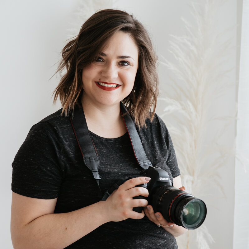 Edmonton Newborn Photographer holding camera