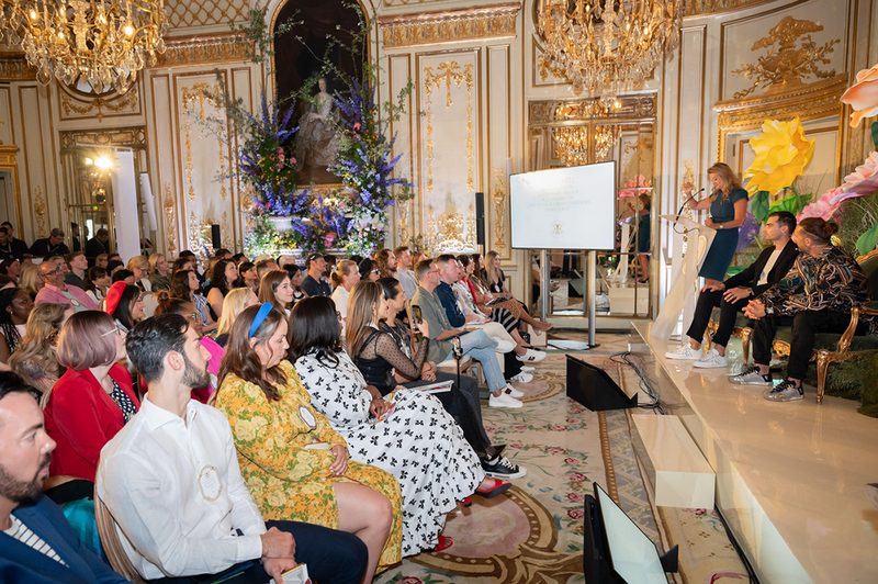 Event planner Alejandra Poupel  speaking at an event