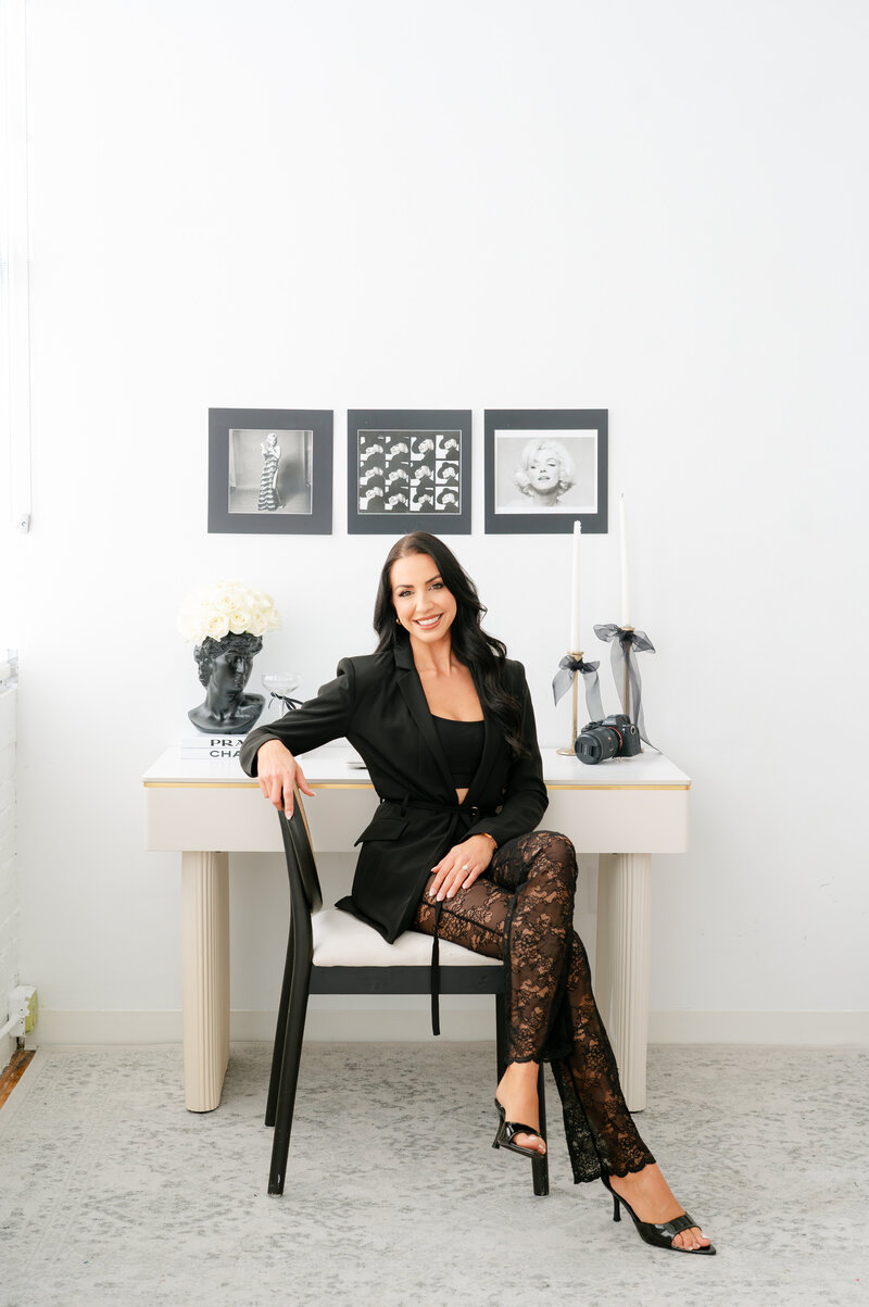 Newport RI Wedding Photographer | Rhode Island Caprio Captured Photography | Stunning Alicia Caprio in a Black Blazer and Lace Pants Sitting on a Chair