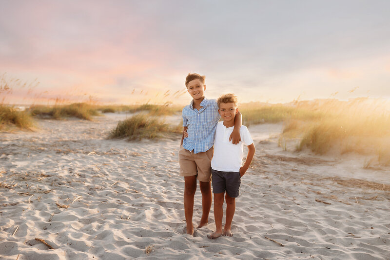 Brothers embrace each other during Family Photoshoot on Isle of Palms in Charleston, South Carolina.