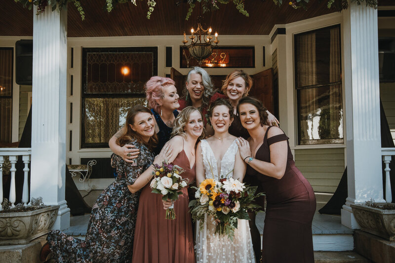 bride and bridesmaids on front porch steps