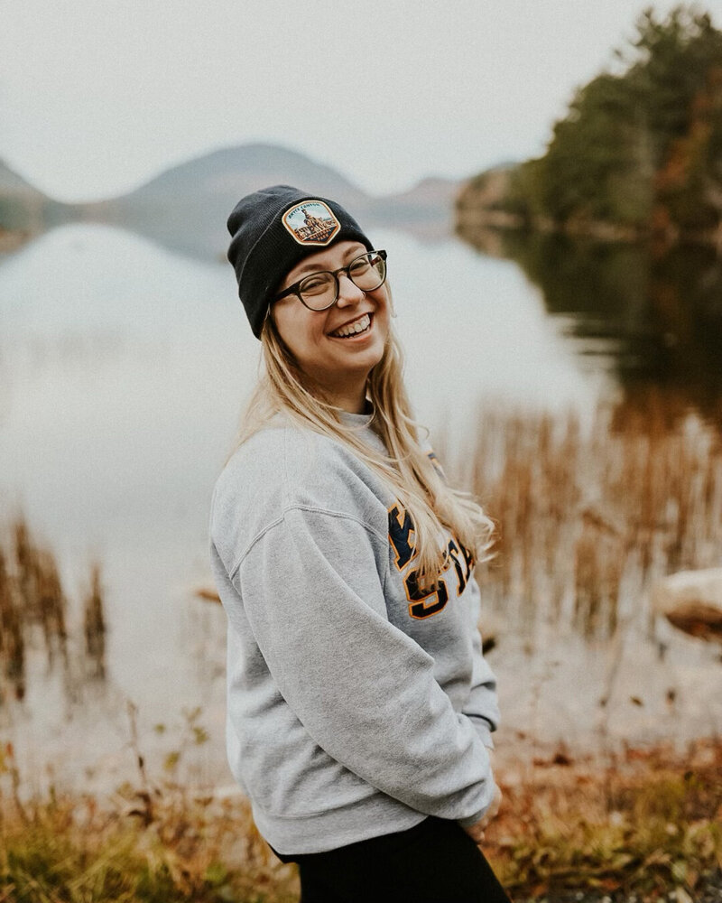 Adventurous photographer standing in front of lake at Acadia National Park, Maine