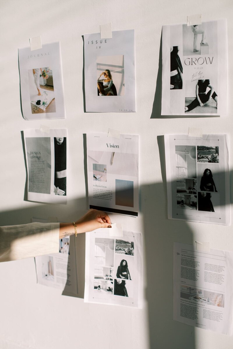 Hunted Aesthetic team member sticking branding mood board to wall