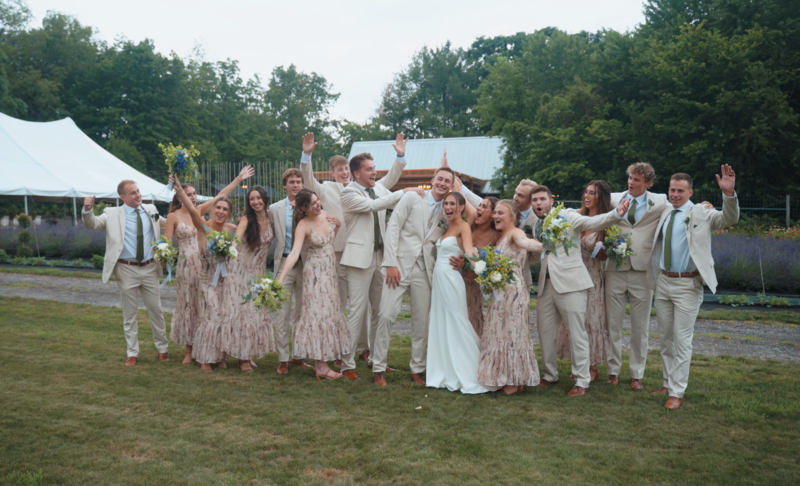 bride and groom celebrating with their wedding party