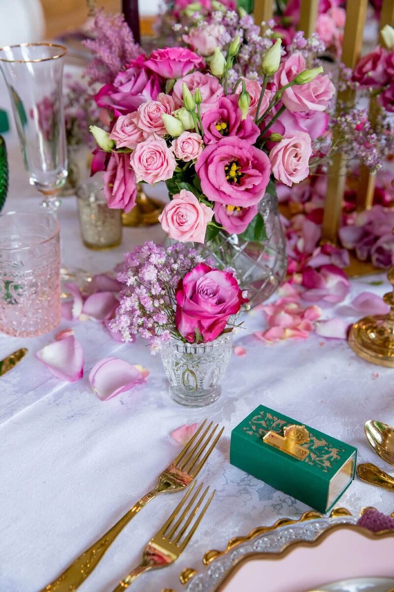 Beautiful table setting with gold cutlery, bespoke favour box and floral display