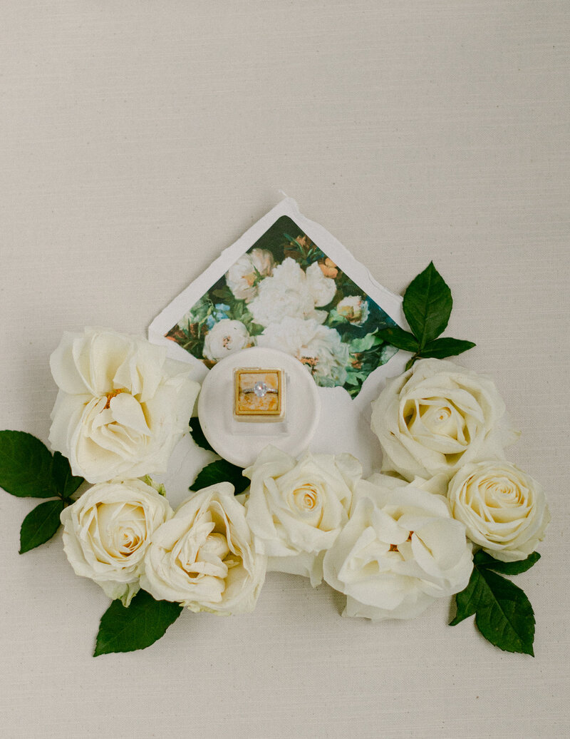 Natural linen flat lay mat with vintage stamps and florals for wedding styling