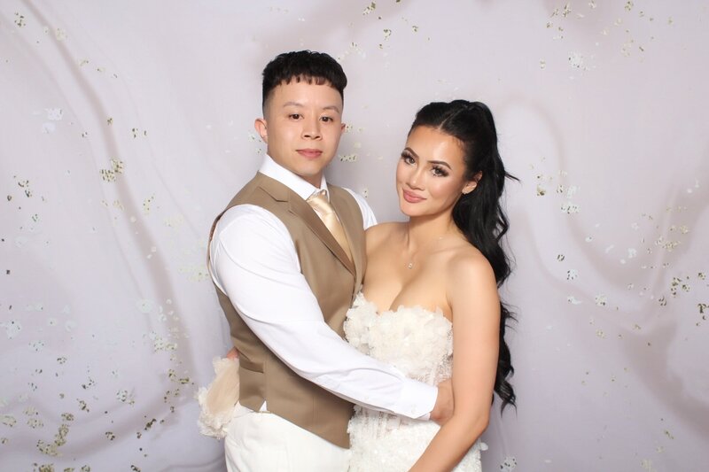Bride and Groom pose for glam beauty filter photo booth 