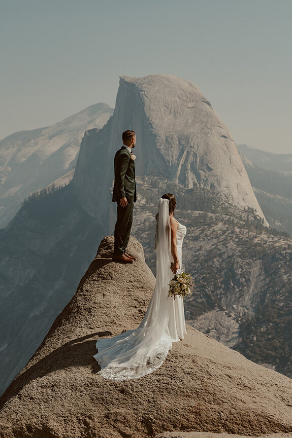 bride and groom at glacier point on wedding day in yosemite