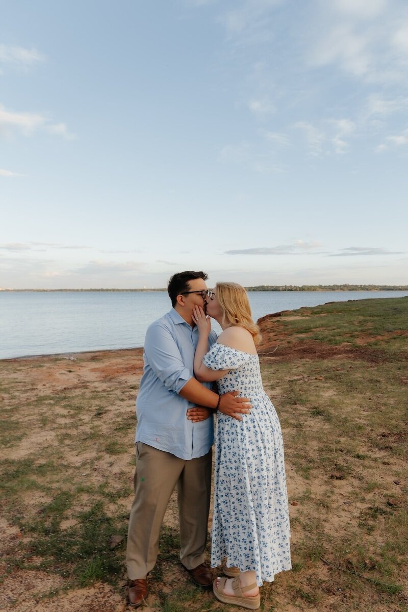 couple kisses next to lake in texas
