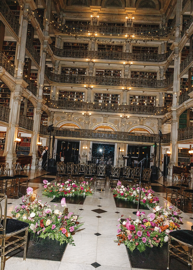 Flowers and chairs set up for a wedding at the George Peabody Library
