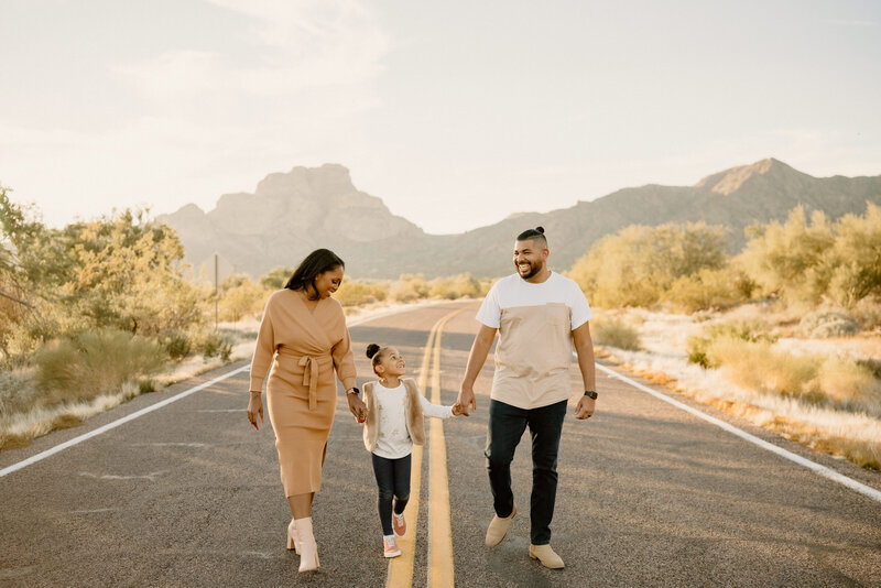 parents walk with daughter down arizona road