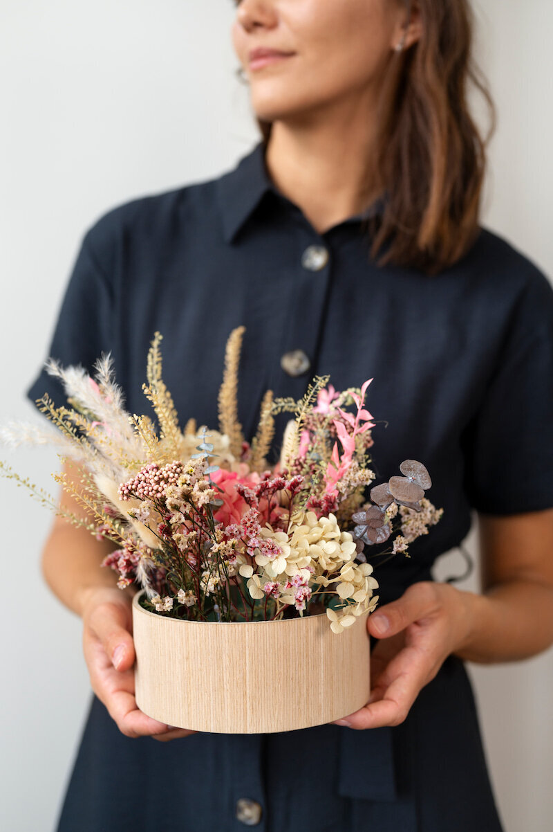 front-view-smiley-woman-holding-flowers