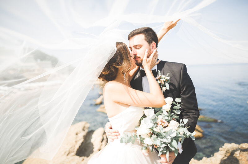 Bride and groom by the coast following their coastal wedding ceremony.