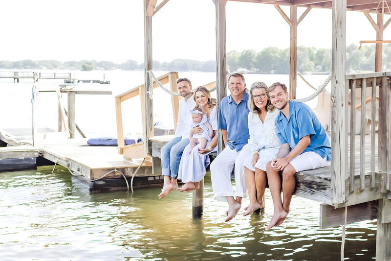 Family sitting on dock on Lake Norman during family photo session