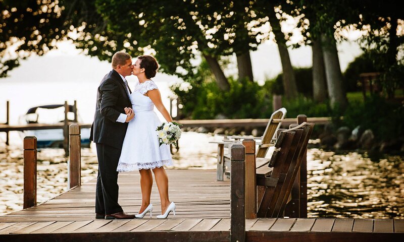 wedding couple on dock of lake