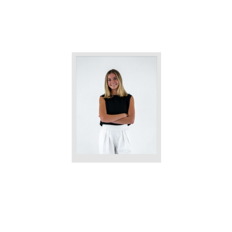 Polaroid image of a girl smiling with arms crossed