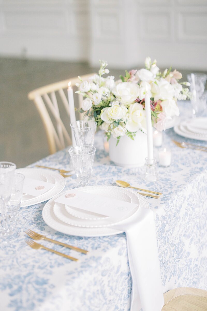delicate wedding tablescape in blue and gold accents