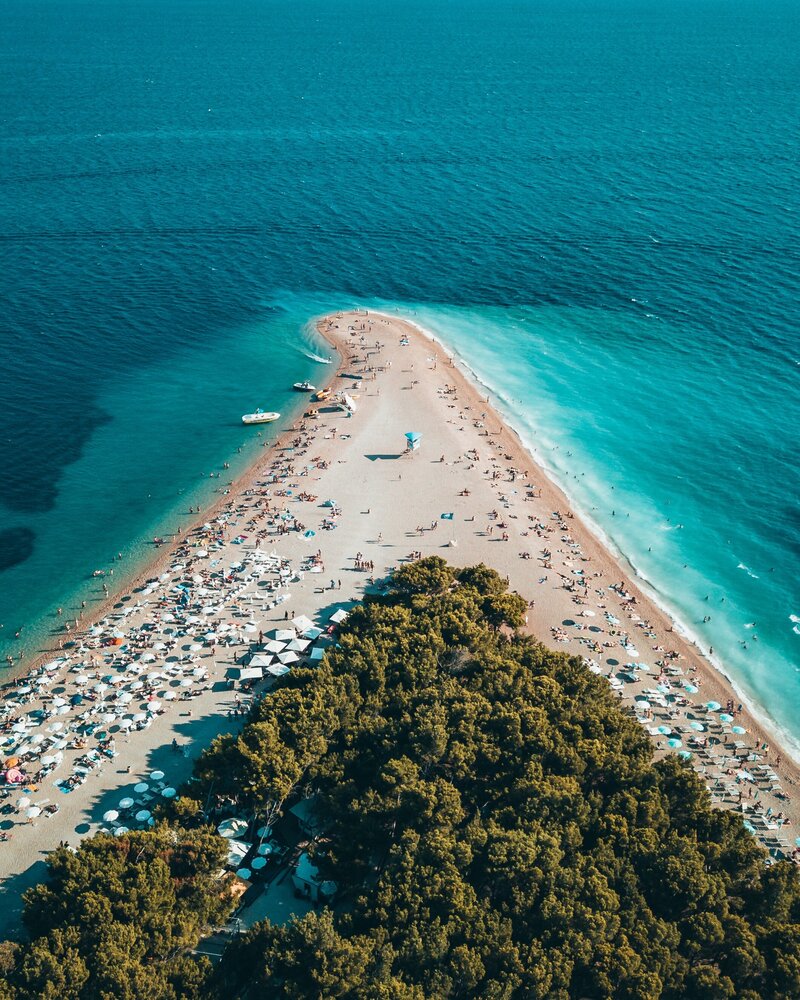 Arial view of Bol beach with turquoise sea waters with people enjoying the beach on the island of Brac in Croatia