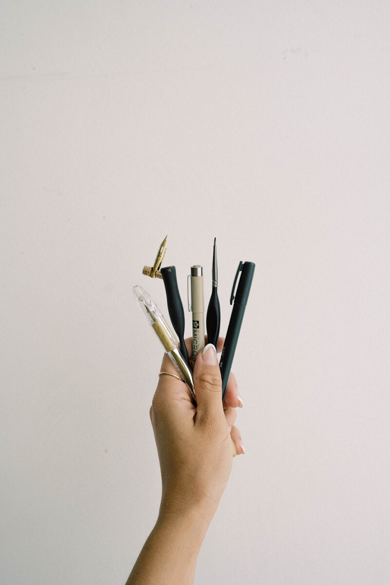 Cat Lauren Calligraphy with calligraphy tools in hand
