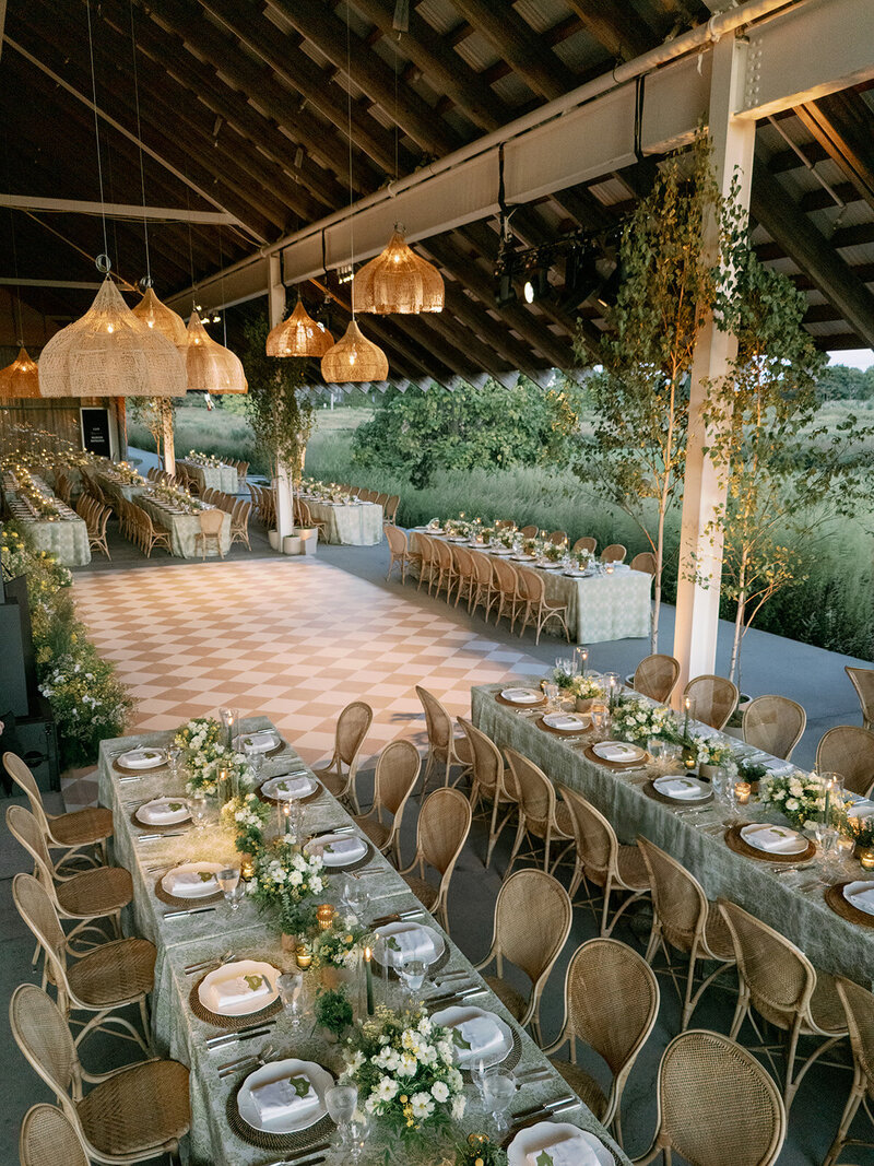 Bride in custom Monique Lhuillier wedding gown walks with groom at their wedding in Miami, FL