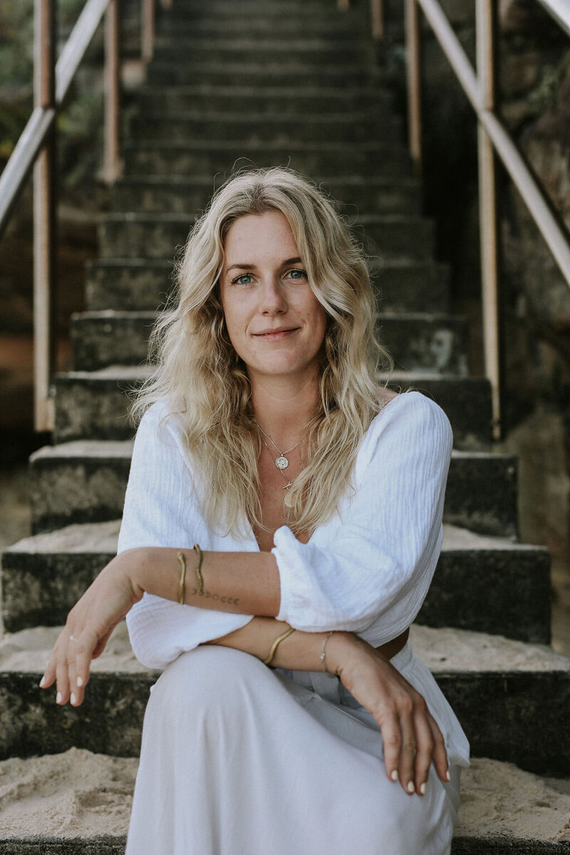 Woman sitting on staircase looking into the camera