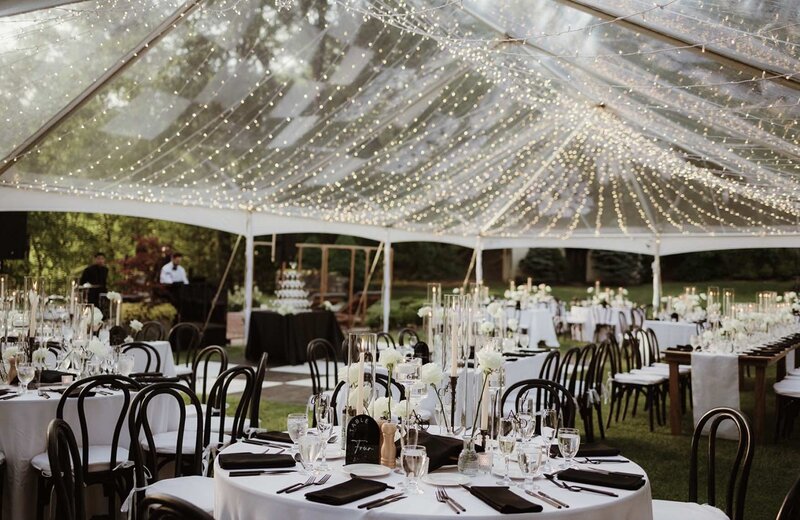 Tented reception space at a wedding with twinkle lights