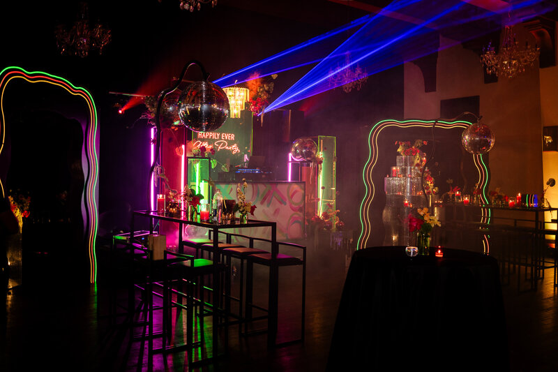 Dark wedding reception with neon lights planned by Bloom & Blueprint