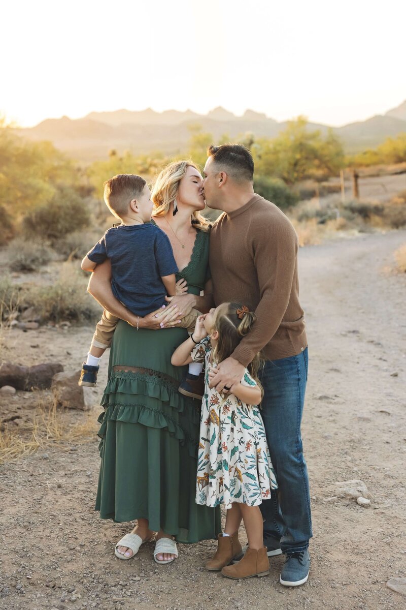 Children watching their parents kiss in a field in Denver, Colorado