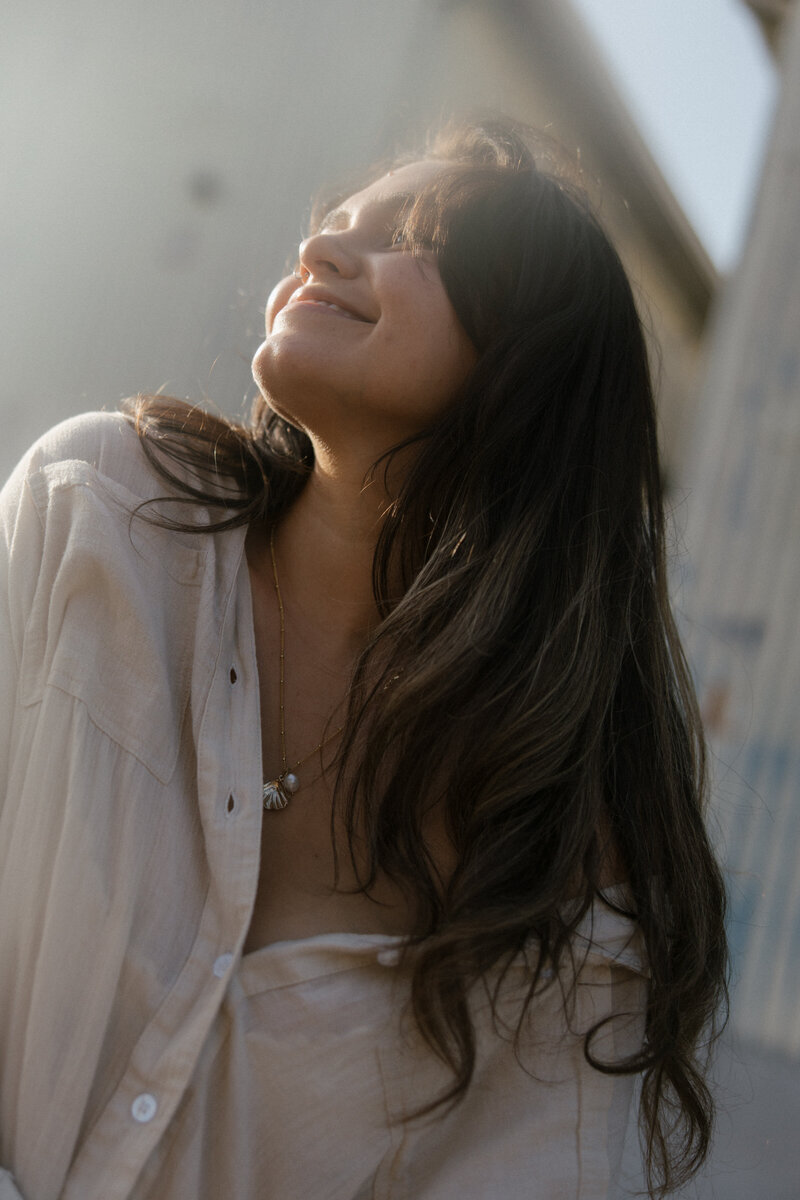 girl holding up camera and smiling