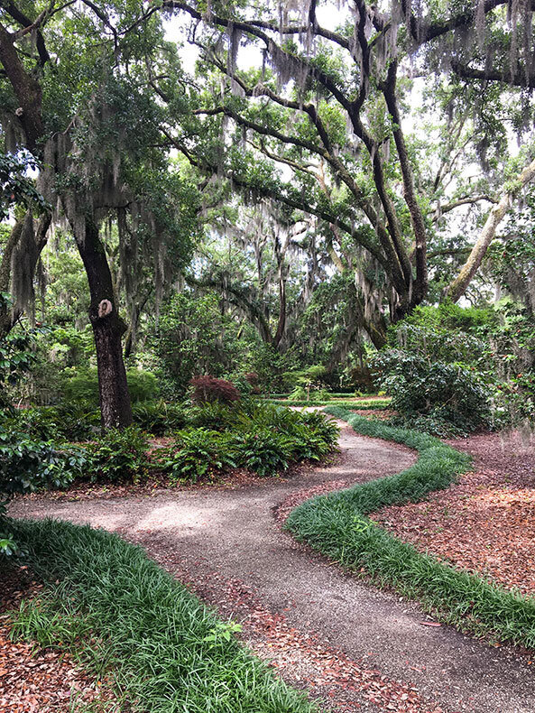 Romantic garden path under moss-draped oaks at Airlie Gardens, a wedding venue in Wilmington NC