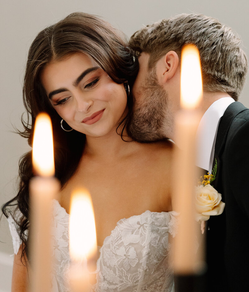 close up shot of groom kissing brides' neck at wedding  reception
