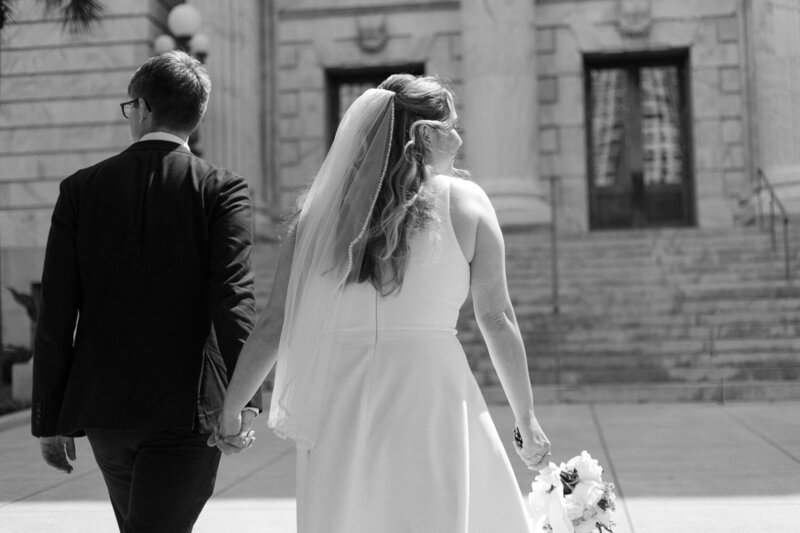 portraits of a couple popping champagne during their florida elopement