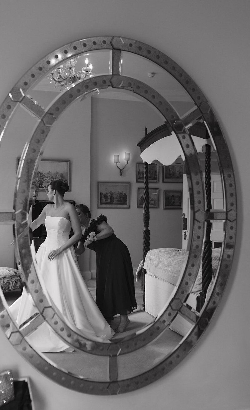 Bride getting ready on wedding morning with mother of the bride