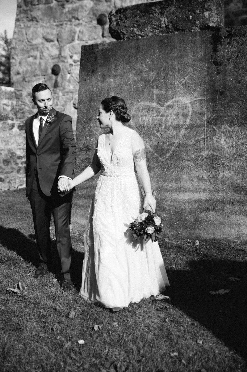 Portrait of Bride and groom standing in front of a heart, at the Lock Ridge Park and Furnace Museum in St. Alburtis PA