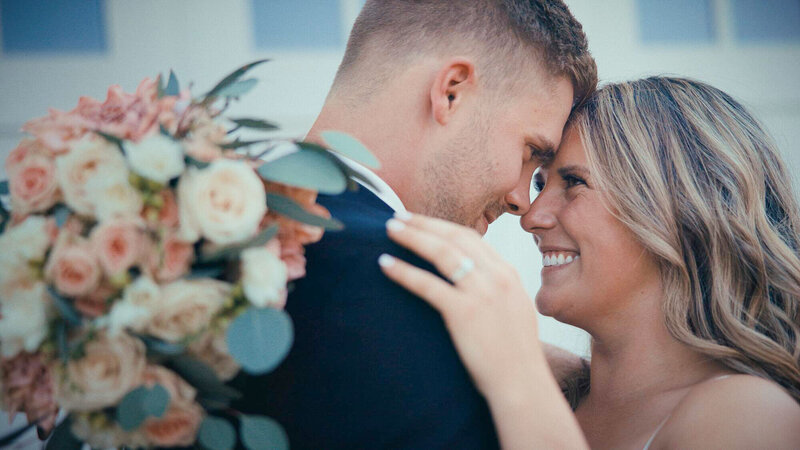 A bride and groom embrace at their wedding in this wedding film frame - Films by Brian