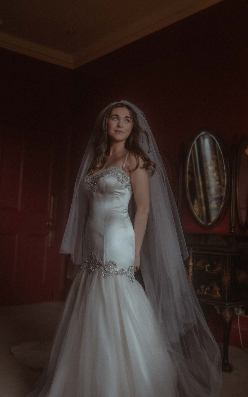Stunning bride in her wedding dress, captured in a beautiful and timeless portrait that showcases grace, elegance, and joy on her special day